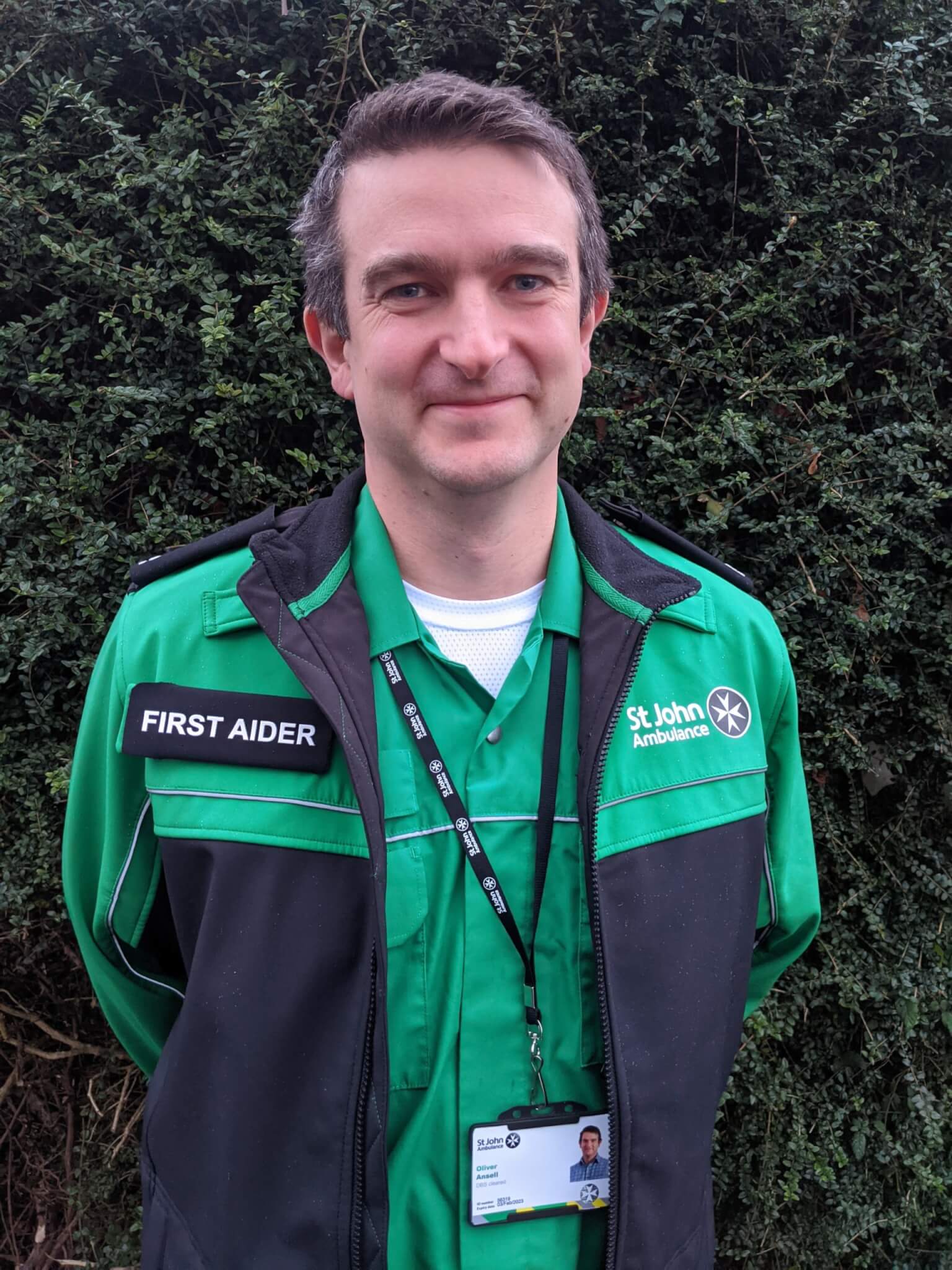Picture of Olly Ansell, a KLA employee, in his First Aid uniform for national volunteer month.